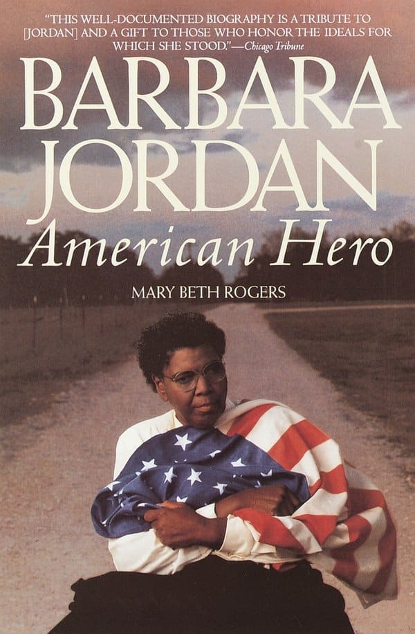 A sepia-toned picture of Barbara C. Jordan on a country road, wrapped in an American flag